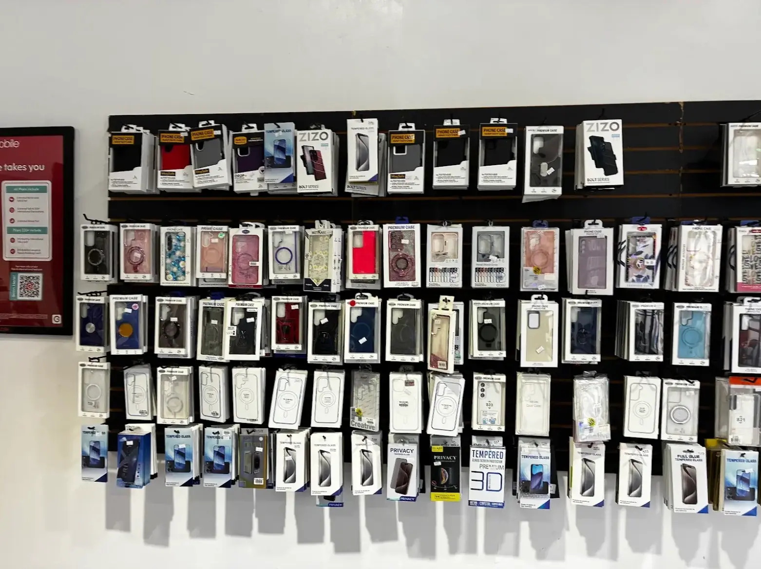 Wall of iPhone and Samsung Galaxy cases and tempered glass at TIC Wireless
