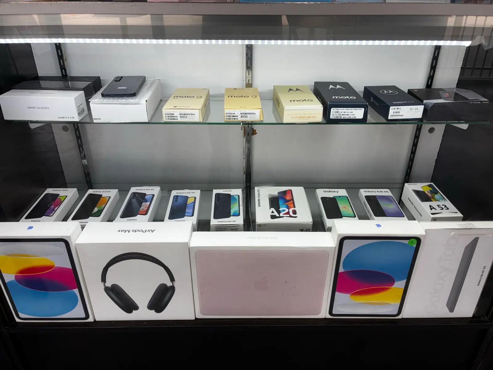 AirPods Max, iPads and Galaxy boxes in the display case