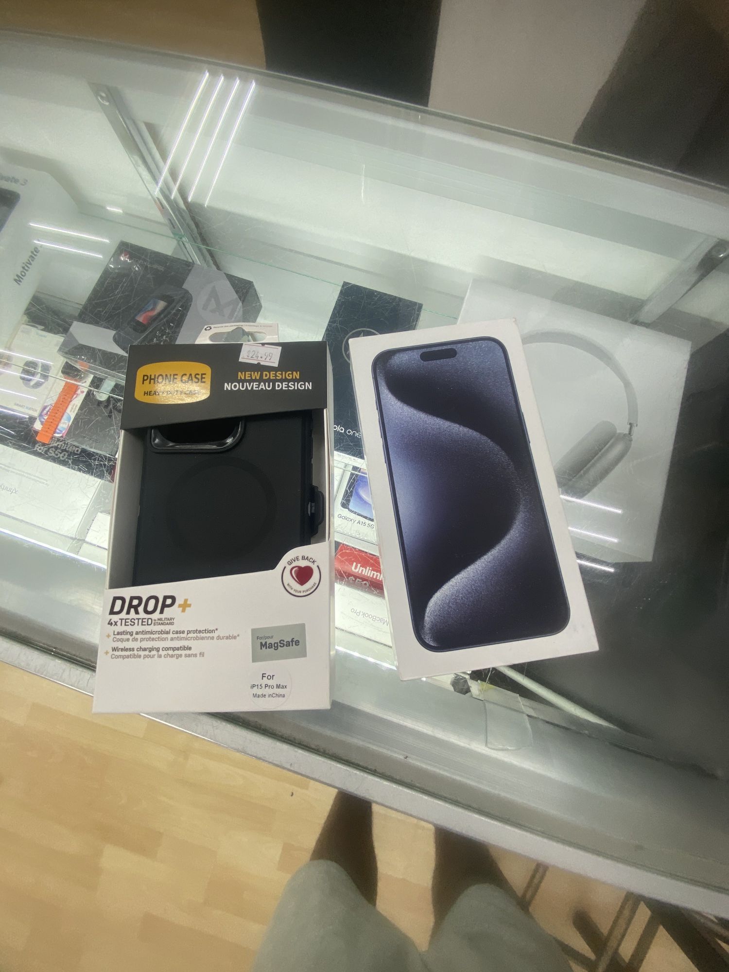 Boxed iPhone 15 Pro with an OtterBox case