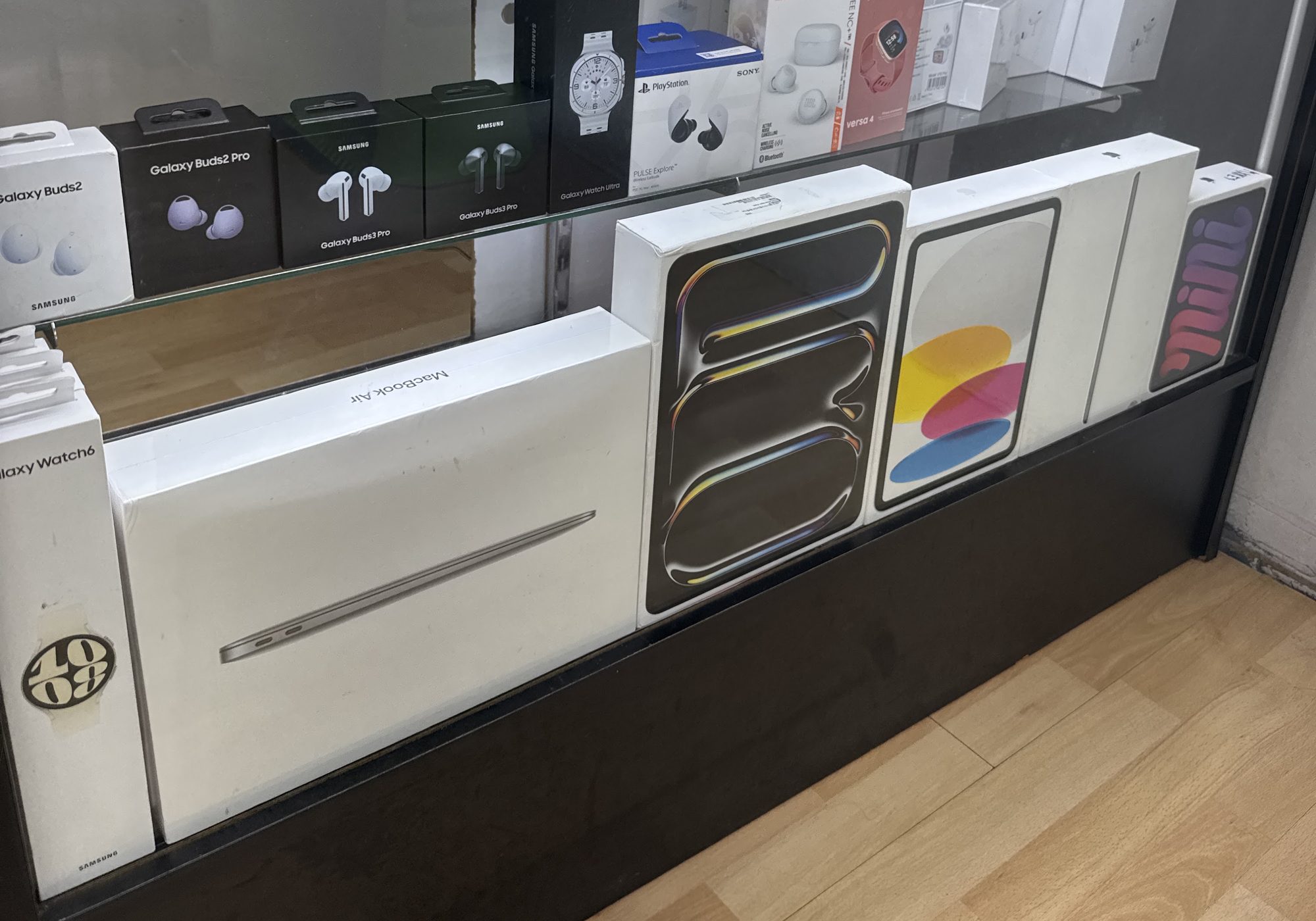 MacBook Air and iPads in a display case