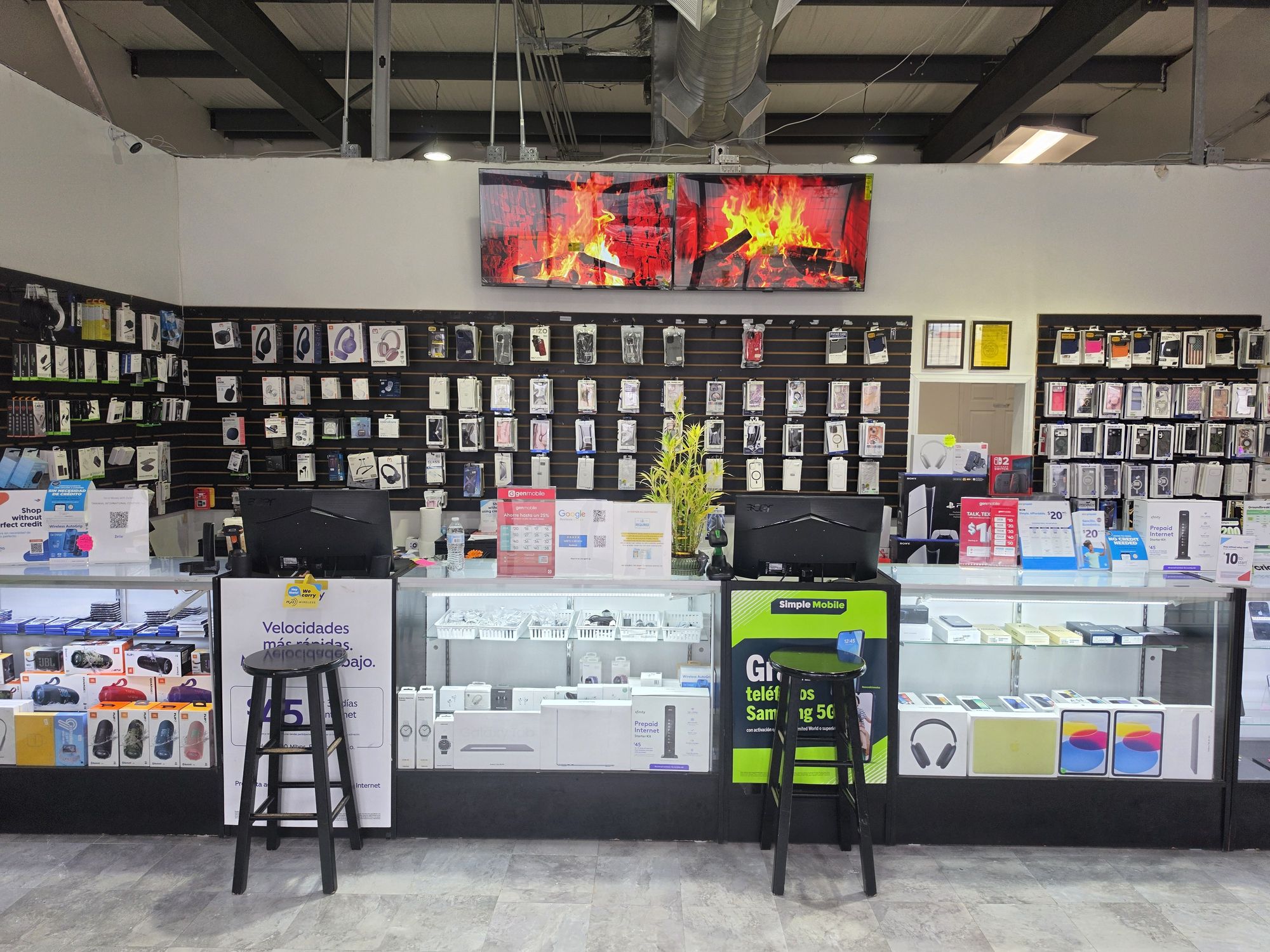 Inside the new TIC Wireless Electronic & Repair Center store on Hillcroft: glass display counters, accessory walls and service stations